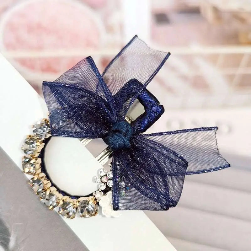 Elegant rhinestone mesh navy blue sheer bow hairpin with gold-toned band and white floral accents hairpin fashion lace