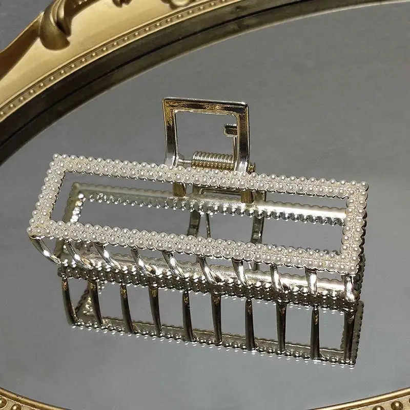 Elegant sweet pearl silver claw clip with a frame adorned by beaded border and intricate metal detailing