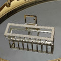 Elegant sweet pearl silver claw clip with a frame adorned by beaded border and intricate metal detailing
