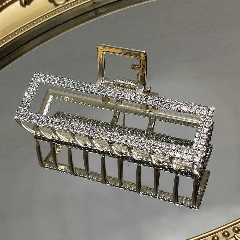 Elegant sweet pearl silver claw clip with a rectangular frame adorned with silver rhinestone-encrusted metal bars