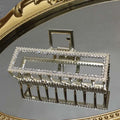 Elegant sweet pearl silver claw clip with a silver frame adorned with sparkling rhinestones and beaded edges