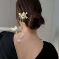Elegant white floral temperament hairpin featuring delicate dangling pearl-like blossoms and gold-toned chains