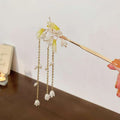 Elegant white floral temperament hairpin with gold tone, translucent jade flowers, and dangling pearl-like chains