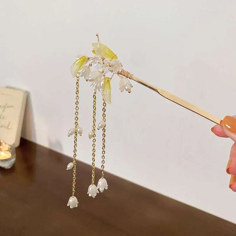 Elegant white floral temperament hairpin with gold tone, translucent jade flowers, and dangling pearl-like chains
