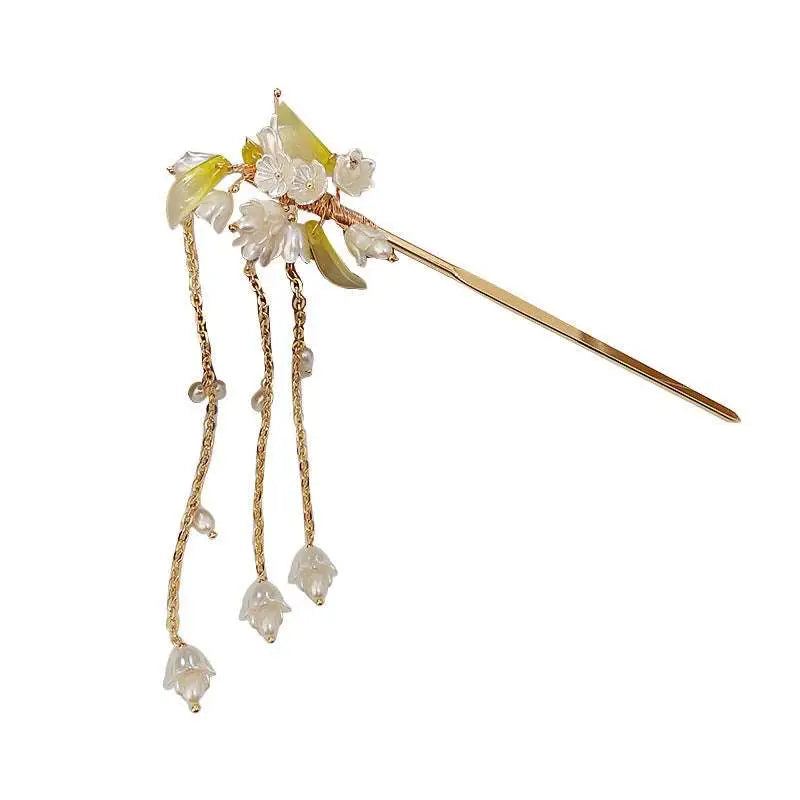 Elegant white floral temperament hairpin with gold-tone finish and dangling pearl-like charms on twisted chains