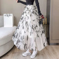 A flowing white lace mesh skirt with embroidered bow lace and black butterfly embroidery paired with a ribbed black top
