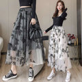 Two women model mid-length embroidered bow lace mesh skirts with black butterfly embroidery on gray and white mesh