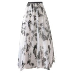 A flowing white mid-length lace mesh skirt with embroidered bow lace featuring intricate black butterfly embroidery