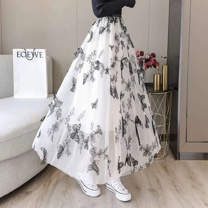 A flowing white lace mesh skirt with embroidered bow lace and intricate black butterfly embroidery mid-length design