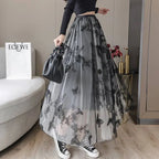 A flowing gray lace mesh skirt featuring intricate black butterfly embroidery and embroidered bow lace details
