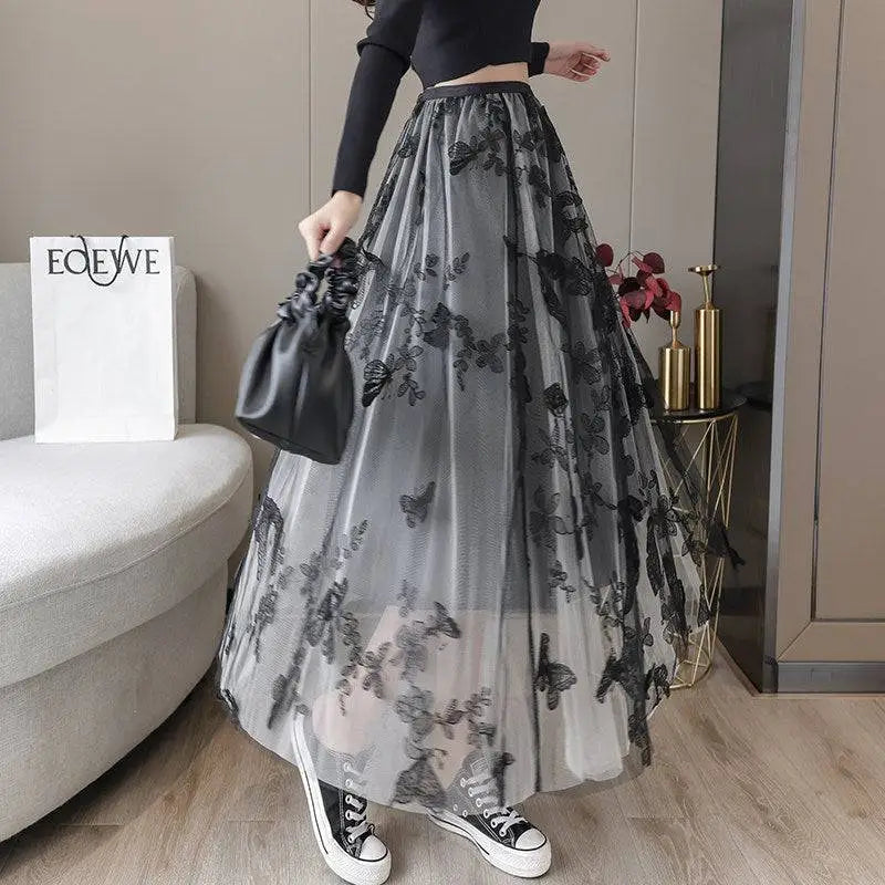 A flowing gray lace mesh skirt featuring intricate black butterfly embroidery and embroidered bow lace details