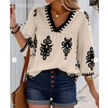 Cream-colored casual vacation blouse with black embroidered floral patterns and a v-neckline for embroidered casual vacation wear