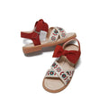 Cream-colored children’s soft-soled sandals with red suede embroidered floral big straps and matching ankle bow