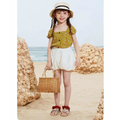 Woven wicker handbag with natural tan handles beside embroidered floral big children’s soft-soled sandals