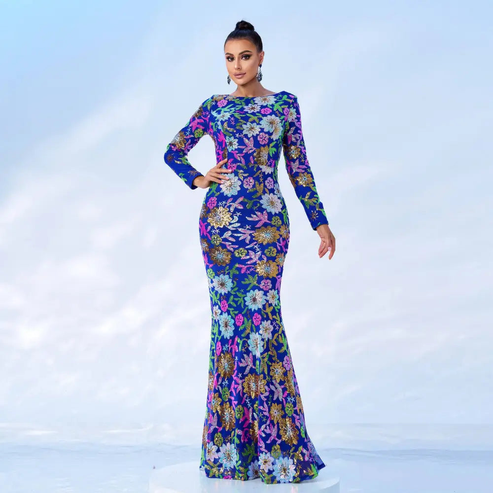 A vibrant royal blue evening gown with embroidered floral pink white and gold details in mermaid style