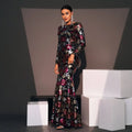 A black long-sleeved evening gown with shimmering burgundy and gold embroidered floral details floor-length
