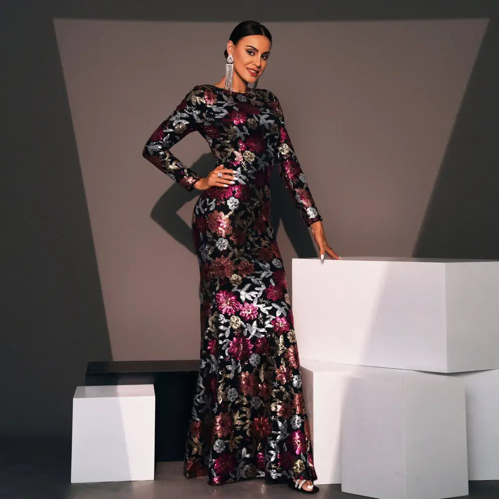 Embroidered floral long sleeve evening gown with black base and shimmering magenta silver and gold floral embroidery