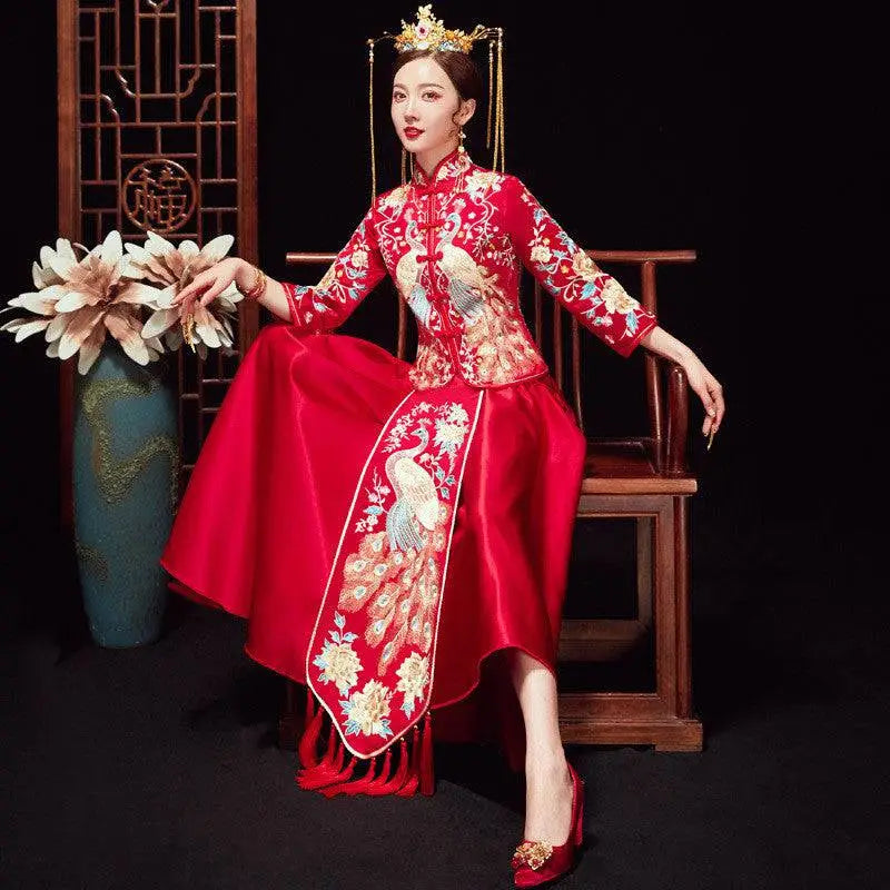 A vibrant red embroidered kimono wedding gown with intricate gold and white peacock embroidery for chinese wedding couples