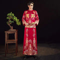 A man wears a vibrant red embroidered kimono with intricate gold dragon embroidery for chinese wedding couples