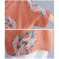 A peach-colored embroidered Korean cotton hemp top with floral embroidery in pink white and blue blossoms