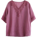 A soft mauve embroidered pink fashion retro cotton linen blouse with detailed embroidery on v-neckline and sleeve cuffs