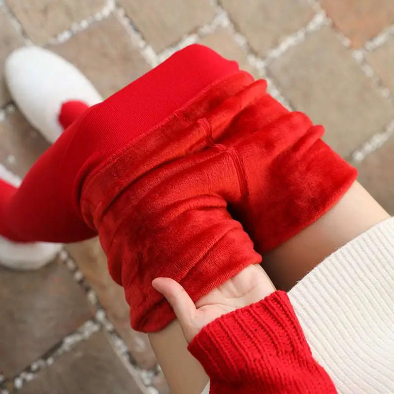 Red stepping pants in plush velvet with ribbed cuffs paired with embroidered red cardigan and nylon single layer design