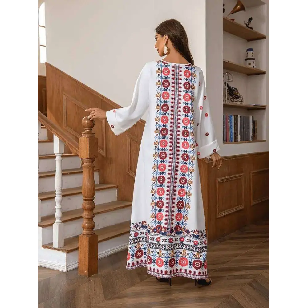 White embroidered rhinestone bead long sleeve maxi dress with intricate red blue and gold floral print on back and hem