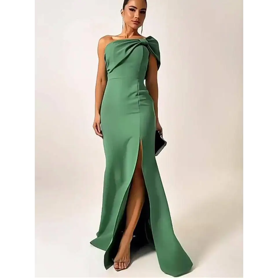 A sleek emerald green satin shoulder evening gown with a dramatic bow and high slit for formal occasions