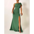 A sleek emerald green bow shoulder evening gown with one shoulder high slit and draped fabric detail