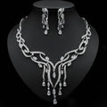 Silver-toned bridal zircon jewelry set featuring intricate emerald green crystal design with cascading teardrop crystals