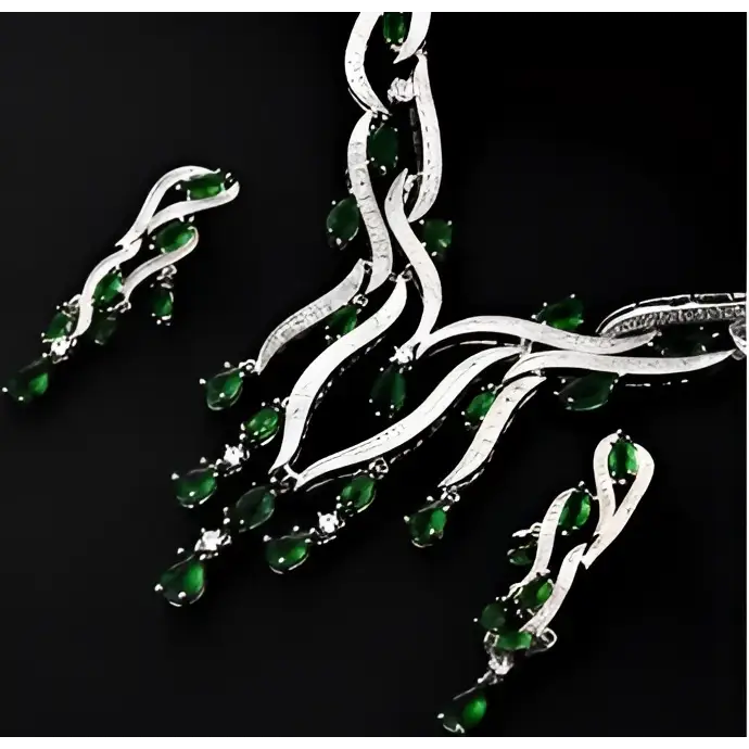 Emerald green crystal zircon jewelry set featuring teardrop gemstones in a flowing silver-toned intricate design