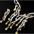 A sparkling silver necklace and earrings zircon jewelry set with vibrant yellow gemstones and emerald green crystal accents