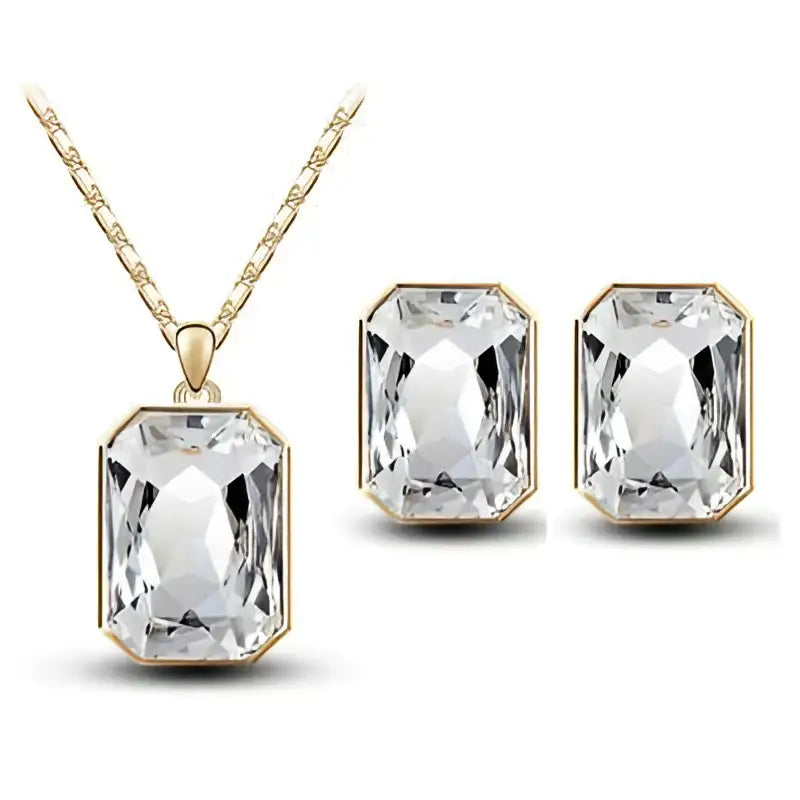 Emerald green crystal necklace set featuring a gold-tone chain with a rectangular clear crystal necklace pendant