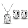 Silver rectangular pendant necklace and matching earrings with emerald green faceted crystal stones in sleek frame