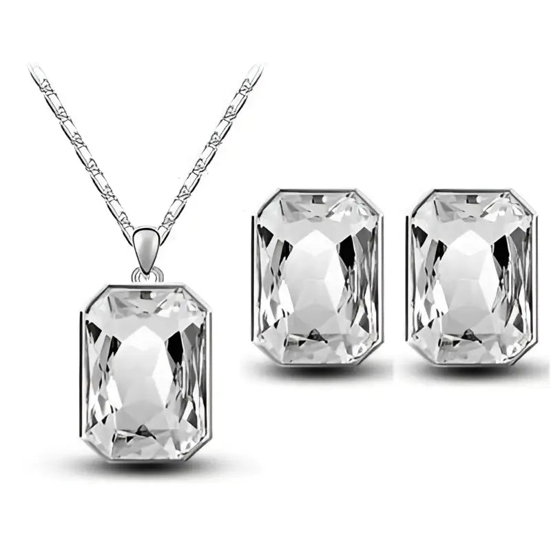 Silver rectangular pendant necklace and matching earrings with emerald green faceted crystal stones in sleek frame