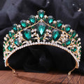 A sparkling gold fashion bridal knot tiara with emerald green teardrop crystals and clear rhinestones in leaf design