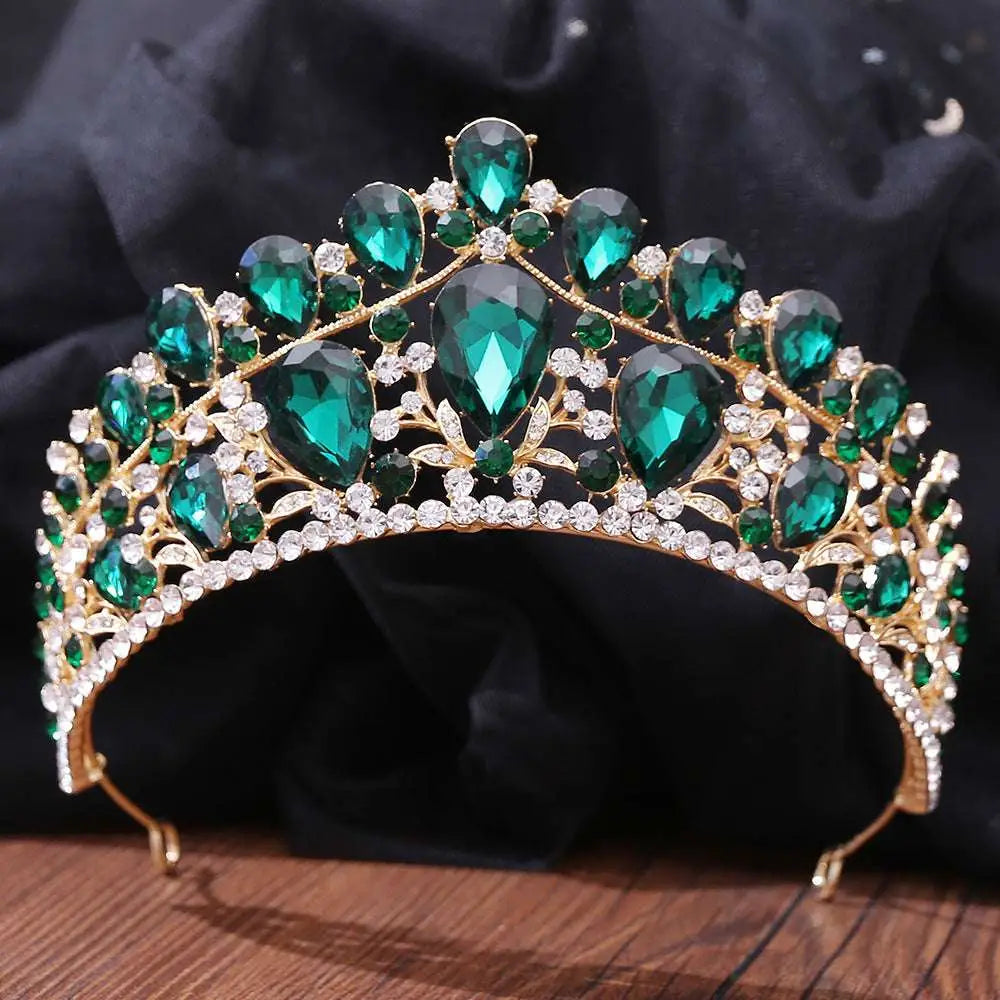 A sparkling gold fashion bridal knot tiara with emerald green teardrop crystals and clear rhinestones in leaf design