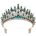 A sparkling gold fashion bridal knot tiara adorned with emerald green and clear crystal teardrop-shaped stones