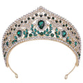 A sparkling gold fashion bridal knot tiara with emerald green and clear rhinestones in an intricate leaf design