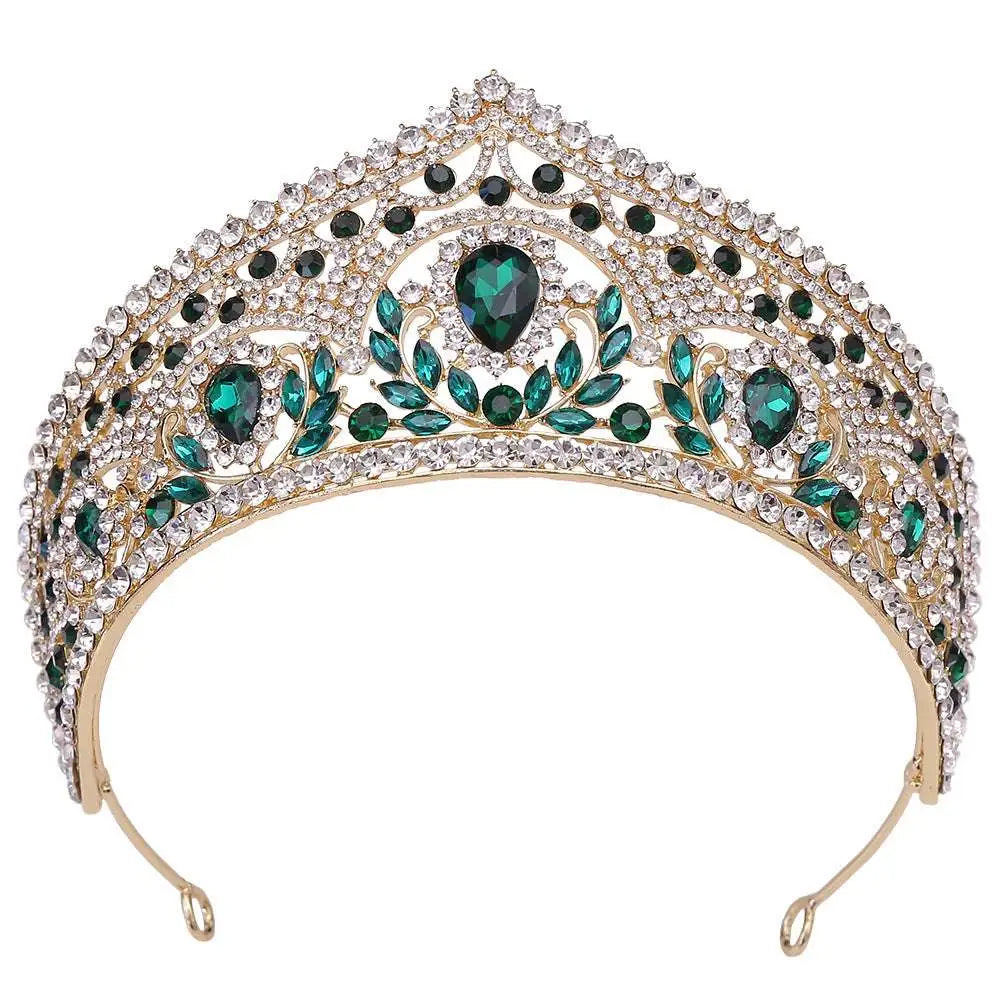 A sparkling gold fashion bridal knot tiara with emerald green and clear rhinestones in an intricate leaf design