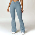 Light blue high-waisted flared leggings with twisted front waistband and side pockets for american hip raise workouts