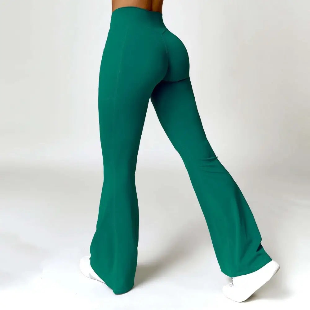 Emerald green high waist yoga pants with american hip raise design in smooth stretchy fabric and front twist detail