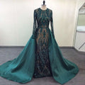 Emerald green satin lace evening dress with long sleeves and a sheer beaded bodice over a flowing train