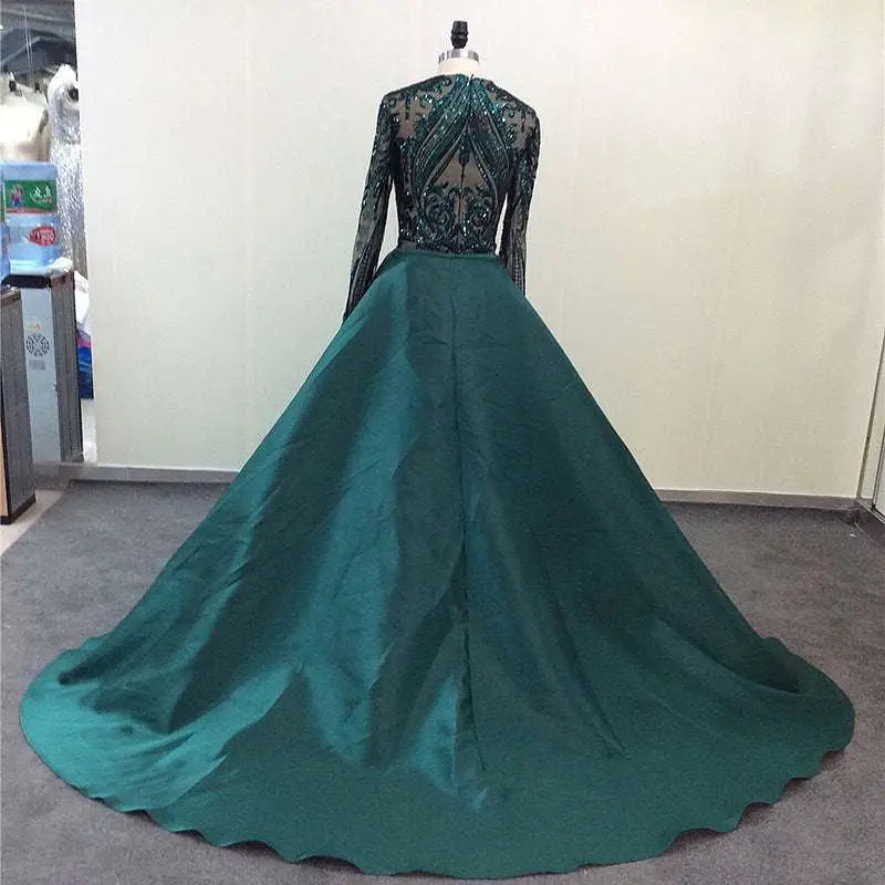 Emerald green satin lace evening dress with a long-sleeved sheer black lace bodice and intricate beading