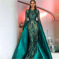 Emerald green satin lace evening dress featuring intricate black sequined embroidery and a flowing train