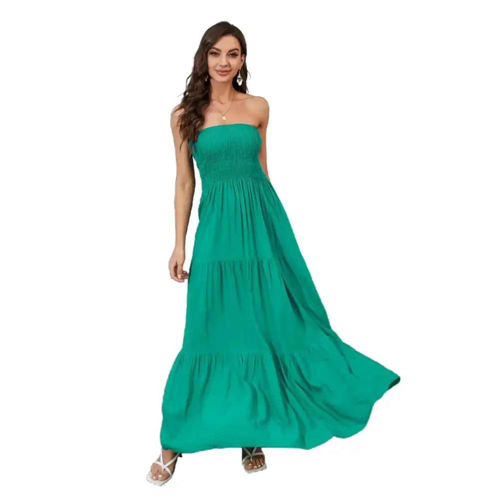 Emerald green strapless tiered maxi dress with smocked bodice and relaxed fit flowing fabric for elegant wear