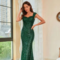 Emerald green suspenders mid waist sequin gown with square neckline and cap sleeves in mermaid silhouette