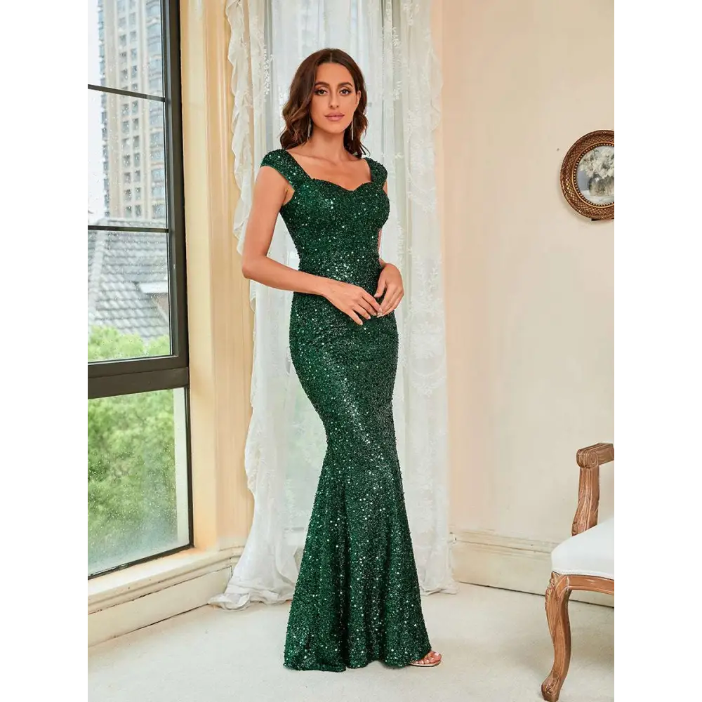 Emerald green suspenders waist sequin gown with cap sleeves featuring a square neckline in a mermaid silhouette