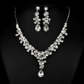 A sparkling silver wedding bride necklace and earrings set with clear crystal floral design for western wedding photography
