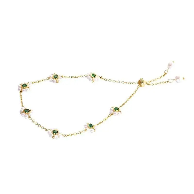 Gold-toned emerald pearl flowers bracelet with delicate floral charms, green gemstones, pearls, and fashion adjustable chain